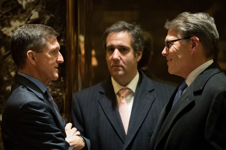 Retired Lt. Gen. Michael Flynn (left), Michael Cohen (center) and former Texas Gov. Rick Perry (right) talk with each other in the lobby at Trump Tower in 2016.