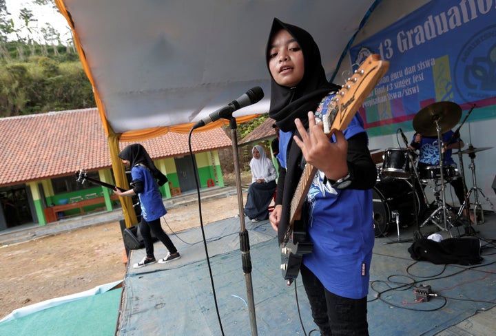 Firdda Kurnia, leader of the metal Hijab band Voice of Baceprot, performs during a school's farewell event in Garut, Indonesia, May 15, 2017.