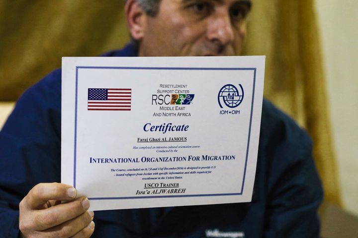 Faraj Ghazi al-Jamous, a Syrian refugee who was prevented from traveling to the United States due to President Donald Trump's executive order, holds out a certificate provided by the International Organization of Migration verifying that he "completed an intensive cultural orientation course" for resettlement, in Amman, Jordan, on Feb. 1, 2017.