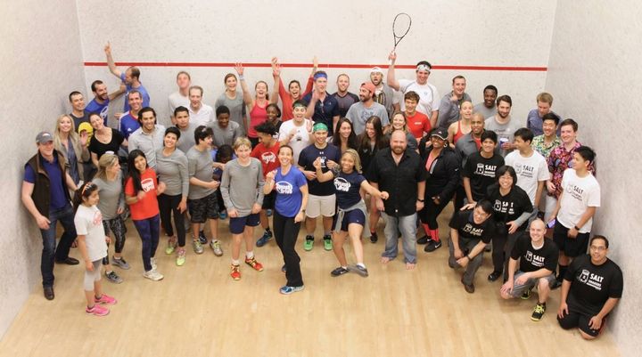 Lauren Patrizio Xaba (center, blue shirt), Founder & Executive Director, with the SquashDrive staff, students and attendees at their annual fundraising event on May 11, 2017. 