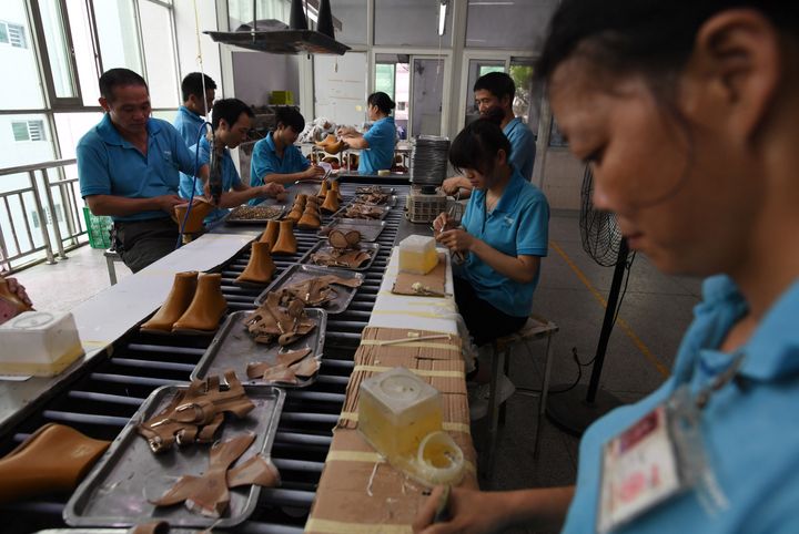 Workers on a production line at the shoe factory in south China's Guangdong province 