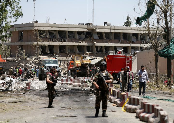 Afghan officials inspect the aftermath of the blast outside the German embassy in Kabul
