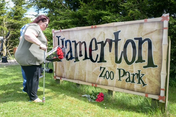 Tracey Eyre and friend laying flowers outside of Hamerton Zoo in Cambridgeshire where Rosa King was killed by a tiger.