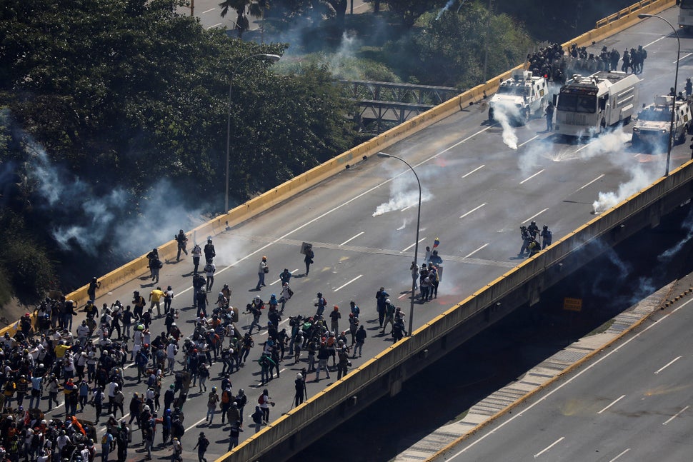 Demonstrators face off against riot security forces at a march to the state ombudsman's office in Caracas, Venezuela, on May