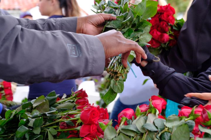 Volunteers grab flowers to place on gravesites are Fort Rosecrans National Cemetery