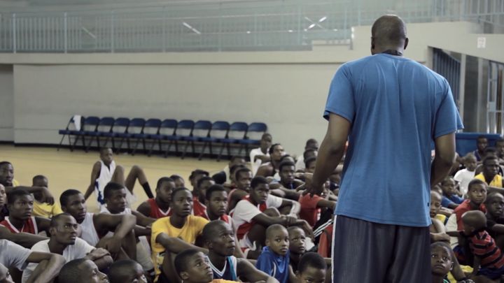 <p>Pierre Valmera giving a speech to a group of aspiring basketball players in Haiti</p>
