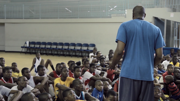 Pierre Valmera giving a speech to a group of aspiring basketball players in Haiti