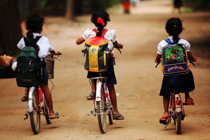 Children riding their bicycles to school in Koh Dach District, Kandal Province. 