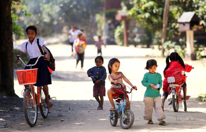 Different priority: Some children are going to school and some are playing. Location: Siem Reap. 