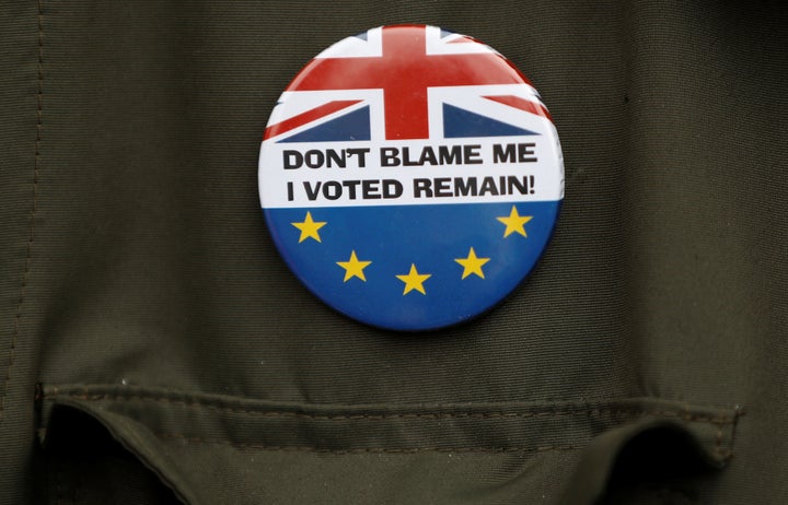 Supporter wears a badge as he waits for Jeremy Corbyn, leader of Britain's opposition Labour Party, to arrive at a campaign event in Reading, England, on May 31, 2017.