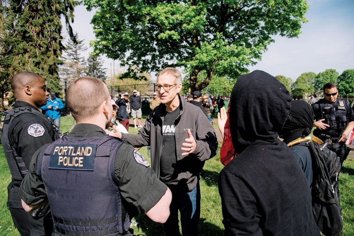 <p>Portland Mayor Ted Wheeler, who is also the Police Commissioner, speaking with police at Trump Free Speech Rally, April 29, 2017.</p>