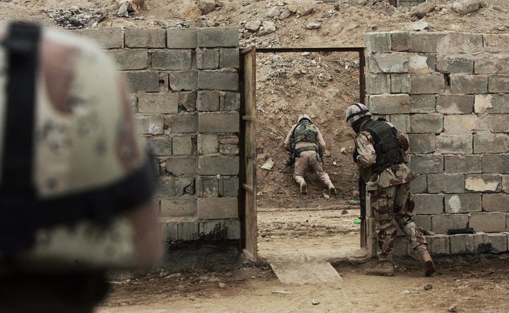 A U.S. soldier defuses a roadside bomb, February 2, 2006 in Khaldiyah, Iraq.