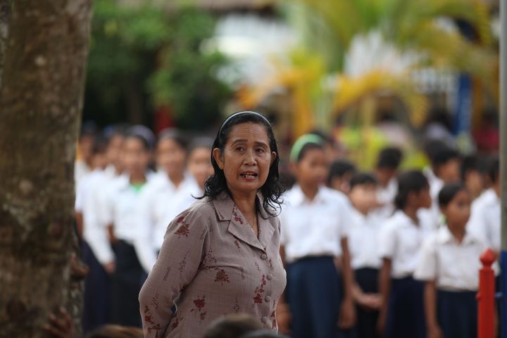 The school principal directing the flag raising ceremony every morning. Location: Spean Chreav Amelio Primary School, Siem Reap. 