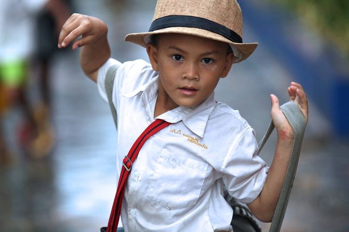 A schoolboy hanging out during school recess. Location: Aranh Sakor CFC Primary School, Siem Reap. 