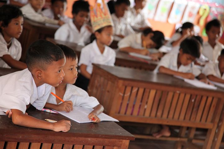 Students busy working at their desks inside the classroom. Location: Aranh Sakor Primary School, Siem Reap. 