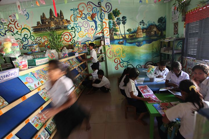 Students reading books during recess inside a library. Location: Bakong Motwani Junior High School, Siem Reap. 