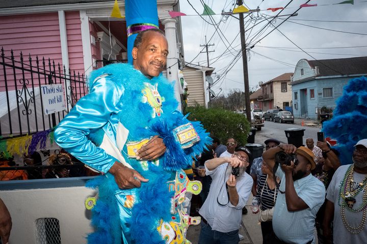 Big Chief Darryl Montana prepares his suit on the steps of his mother’s house, having made this walk previously 48 times. Dedicated fans eagerly wait for him.