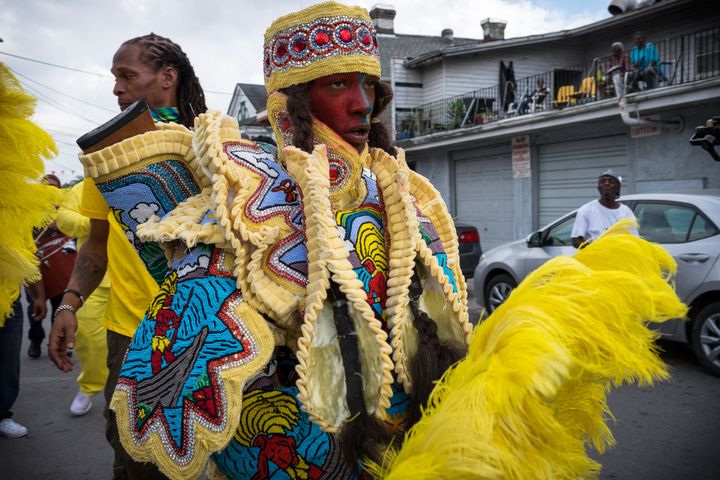 A spyboy from a Black Masking Indian tribe patrols the street in front of Joyce Montana’s house on Carnival Day, February 28, 2017. 