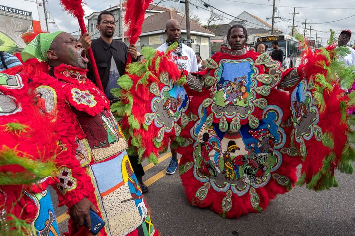 A flagboy and chief from an uptown tribe await a showdown with another tribe on St. Bernard Avenue in New Orleans on Carnival Day, February 28, 2017. Uptown tribes are known for their use of glue and 2-D designs. Downtown tribes are known for their sewing skills and 3-D designs. The Yellow Pocahontas tribe is a downtown tribe. 