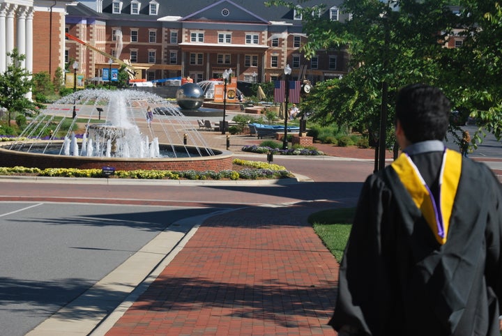 My brother in his gown, graduating after doing 3 years of community college (and construction) and 2 years at a university.