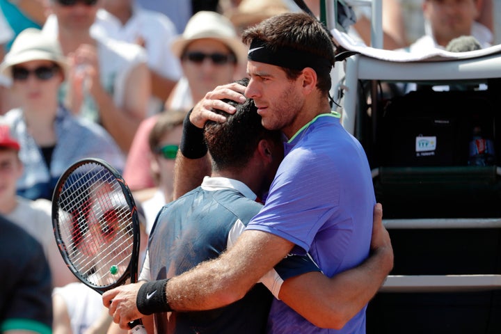 Spain's Nicolás Almagro, left, is comforted by Argentina's Juan Martín del Potro as a knee injury forces him to pull out of their tennis match at the French Open in Paris on Thursday.