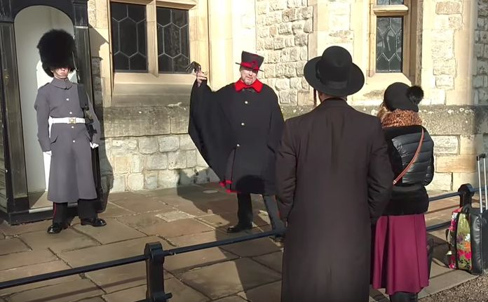 A Beefeater at the Tower of London ticks off a tourist for flinging her glove at the Queen's Guard 