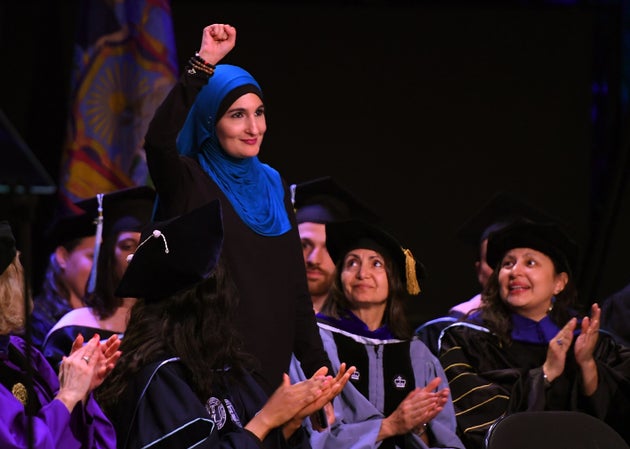 Linda Sarsour raises her fist as she walks to the stage as the keynote speaker at the CUNY Graduate School...
