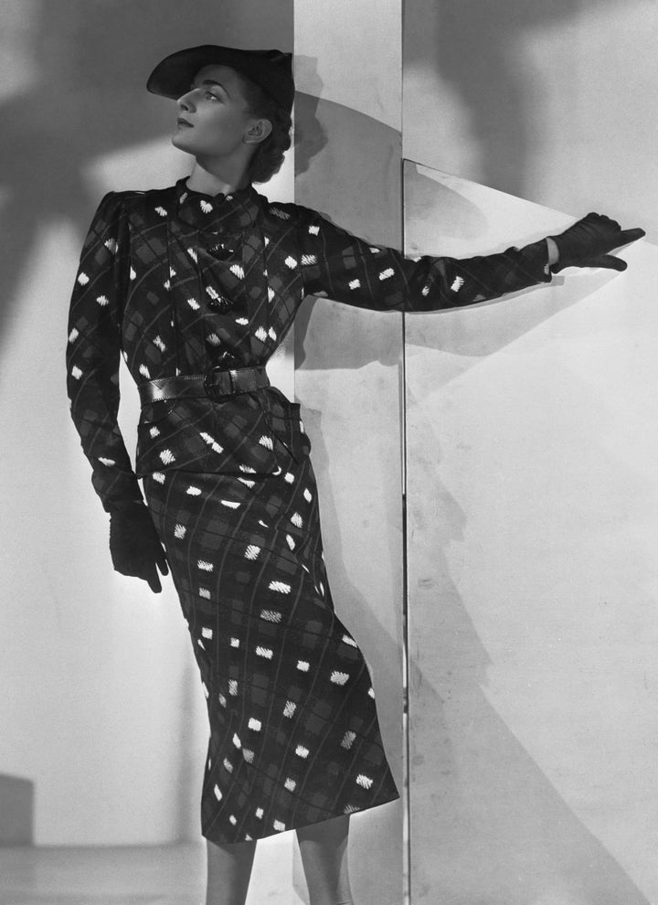 This frock is among the creations (Schiaparelli) chosen by Mrs. Wallis Simpson, to be worn after her 1937 marriage to the Duke of Windsor. Mrs. Simpson's flair for sport clothes is demonstrated in the above. It is a crepe marocain, boldly printed in blue, black and white.