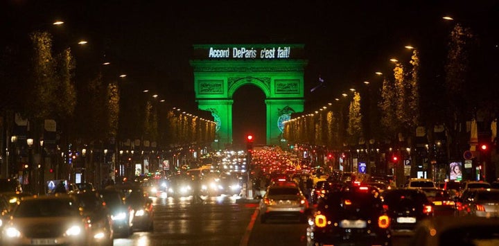The Arc de Triomphe Is illuminated in green to celebrate the Paris Agreement’s entry into force.