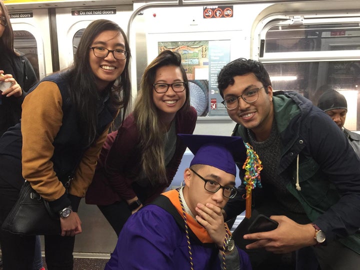 Alcantara and his friends and girlfriend celebrating his graduation on the subway.