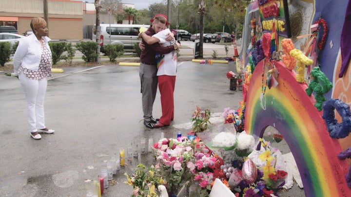 Pulse shooting survivors Chris Littlestar and Orlando Torres embrace at the scene of their shared trauma as life coach Iyanla Vanzant looks on.