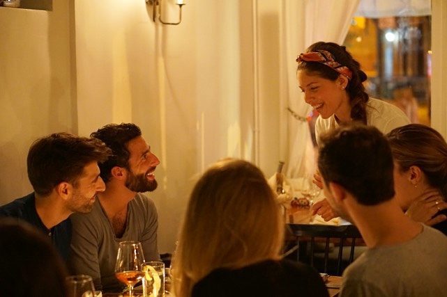 <p>Chef Adriana serving a meal she prepared to hungry guests.</p>