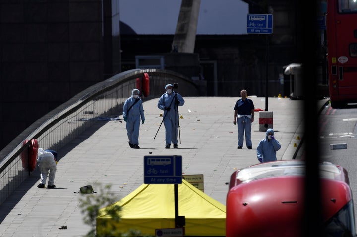 Police forensic investigators collect evidence on London Bridge on Sunday 