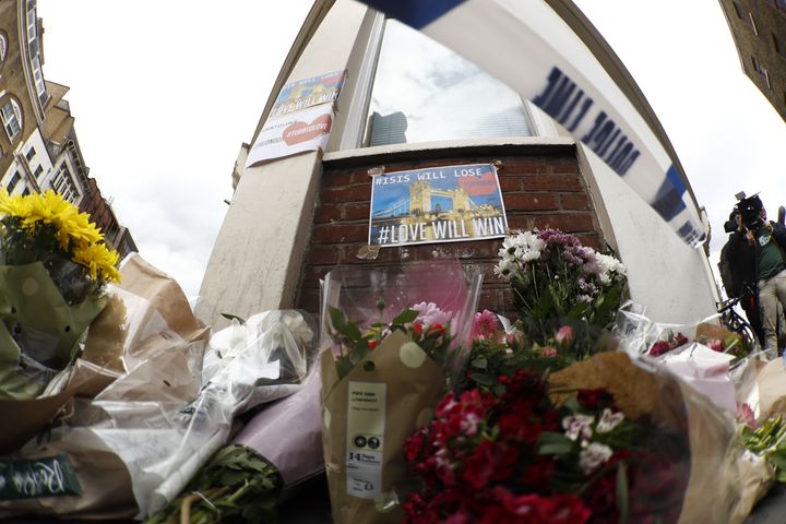 People leave flowers at a police cordon on Borough High Street.