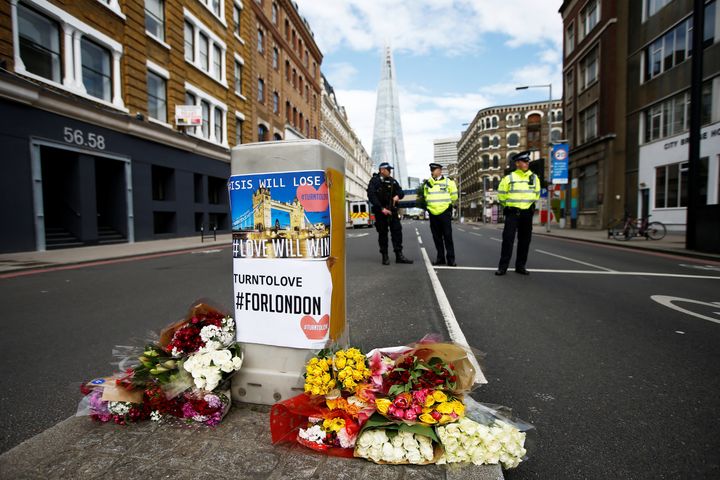 Flowers and messages lie behind police cordon tape near Borough Market.