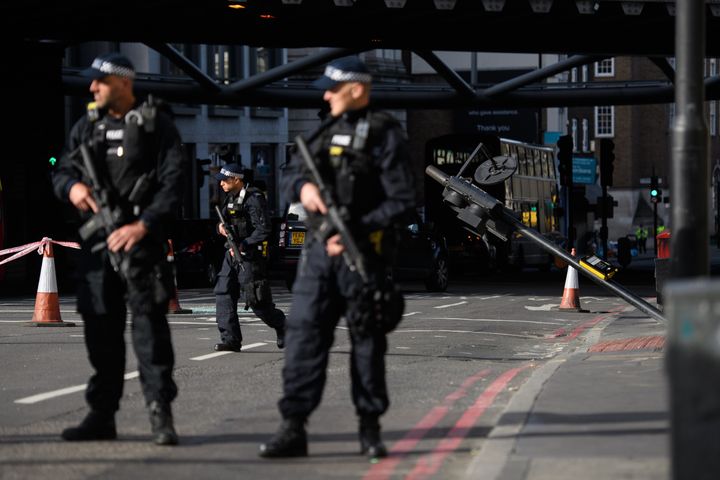 Armed police guard the location on London Bridge where terrorists crashed their van before stabbing people enjoying a night out in nearby Borough Market