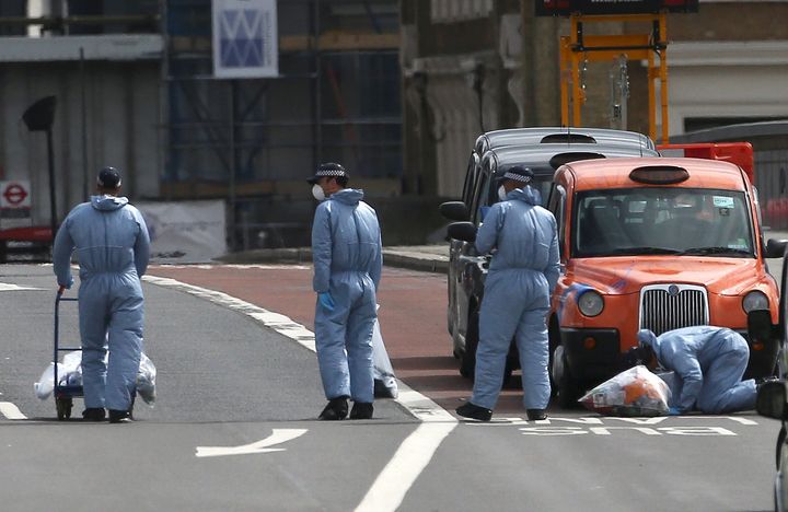 Forensics investigators work on London Bridge the day after the attack 