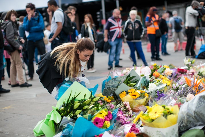 A woman lays flowers among other floral tributes left on London Bridge following the June 3rd terror attack on June 5, 2017 in London, England. Seven people were killed and at least 48 injured in terror attacks on London Bridge and Borough Market on June 3rd.