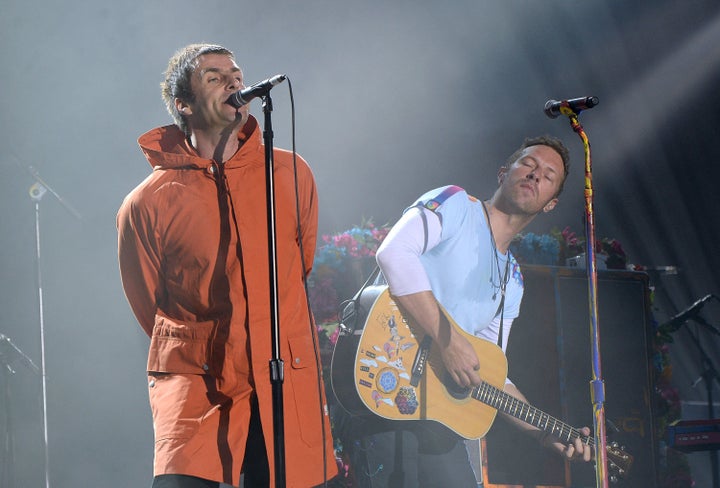 Liam Gallagher (L) and Chris Martin of Coldplay perform on stage during the One Love Manchester Benefit Concert on June 4, 2017.