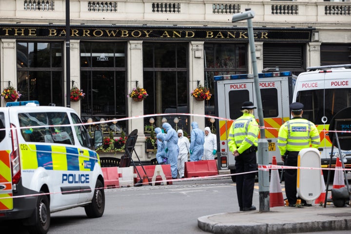 Forensic officers continue their work along Borough High Street Monday the Saturday terror attack in London.