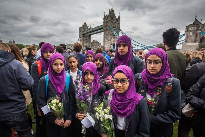 People take part in a vigil Monday for the London terror attacks.