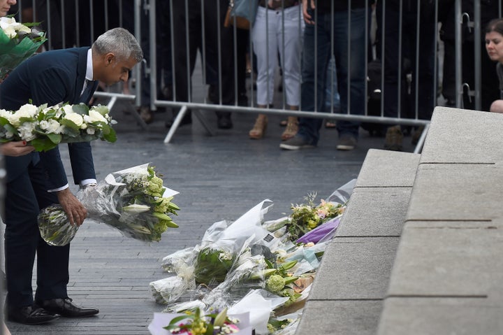 Khan lays flowers near the scene of the attack at London Bridge.