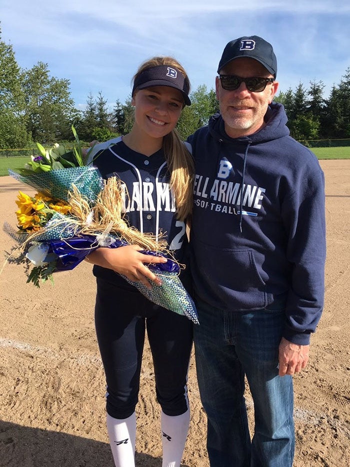 Meg and her dad after a softball game.