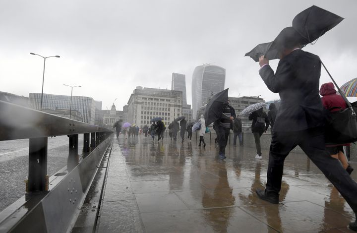 Pedestrians battle the elements in London on Tuesday