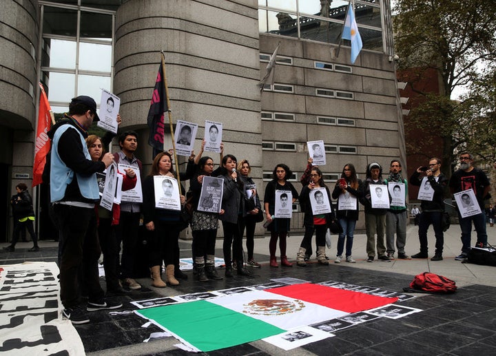 Protesters hold images of murdered journalists.