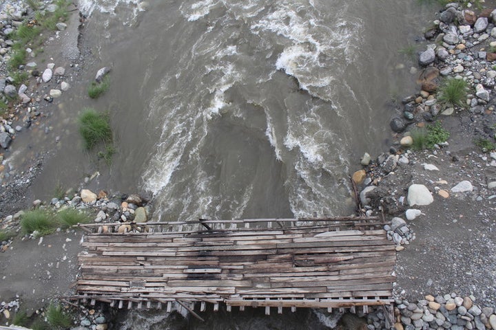 Makeshift wooden plank bridges for motorbikes to cross parts of the braided Dipu Nallah river in the dry season.