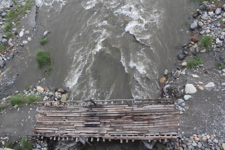  Makeshift wooden plank bridges for motorbikes to cross parts of the braided Dipu Nallah river in the dry season. 