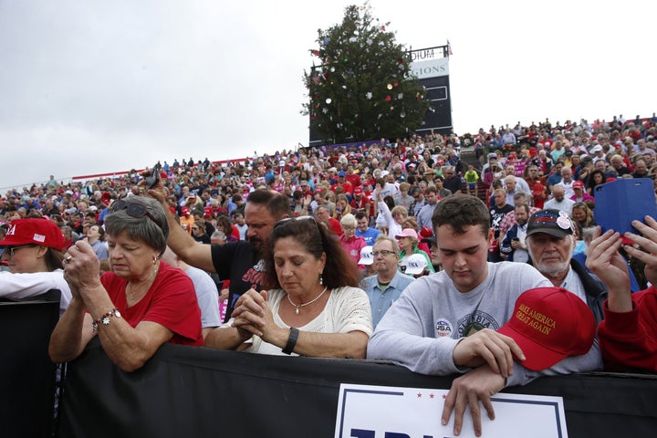 <p>Members of the audience pray while waiting to listen to U.S. President-elect Donald Trump speak during a USA Thank You Tour event in Mobile, Alabama, U.S., December 17, 2016.</p>