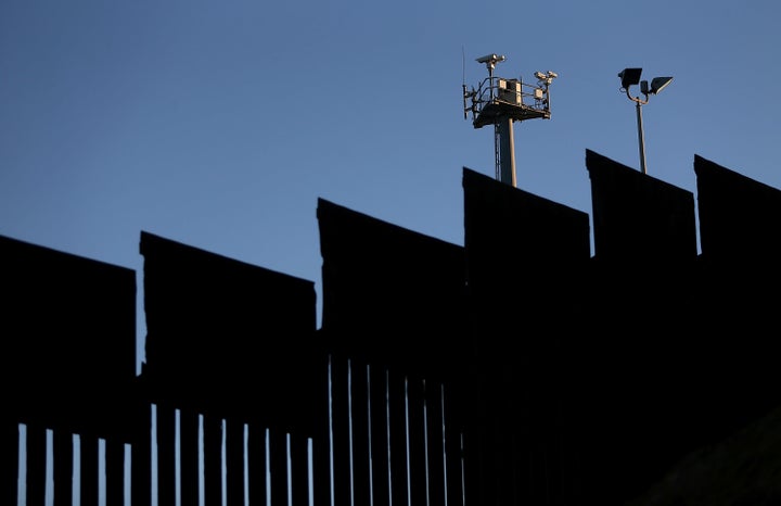 Surveillance cameras tower above the U.S.-Mexico border fence at Playas de Tijuana in Tijuana, Mexico.