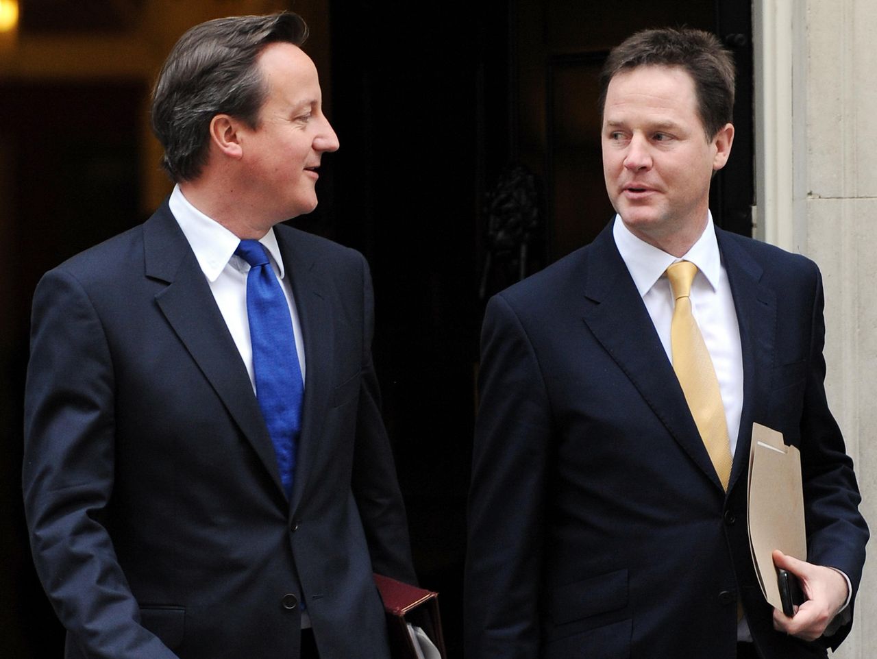 David Cameron and Nick Clegg leave 10 Downing Street during their time in office.